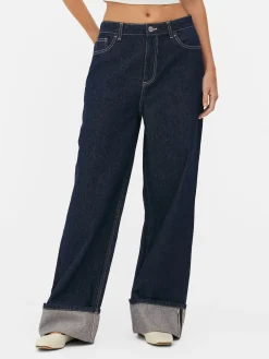 Vaqueros De Pernera Ancha Con Bajos Vueltos